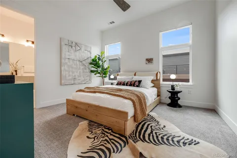 a bed sitting in a bedroom next to a window