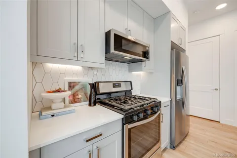 a kitchen with stainless steel appliances a sink a stove and microwave