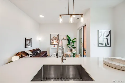 a kitchen with a refrigerator and a sink
