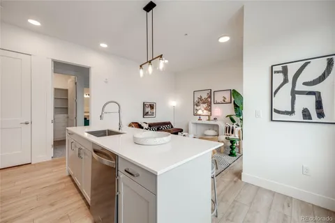 a view of a sink and dishwasher with wooden floor