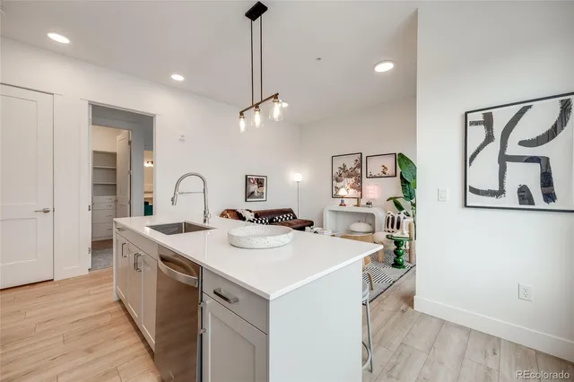 a view of a sink and dishwasher with wooden floor