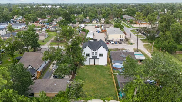 an aerial view of multiple houses with yard