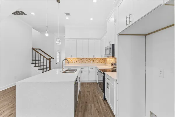 a bathroom with a toilet a sink a mirror and vanity