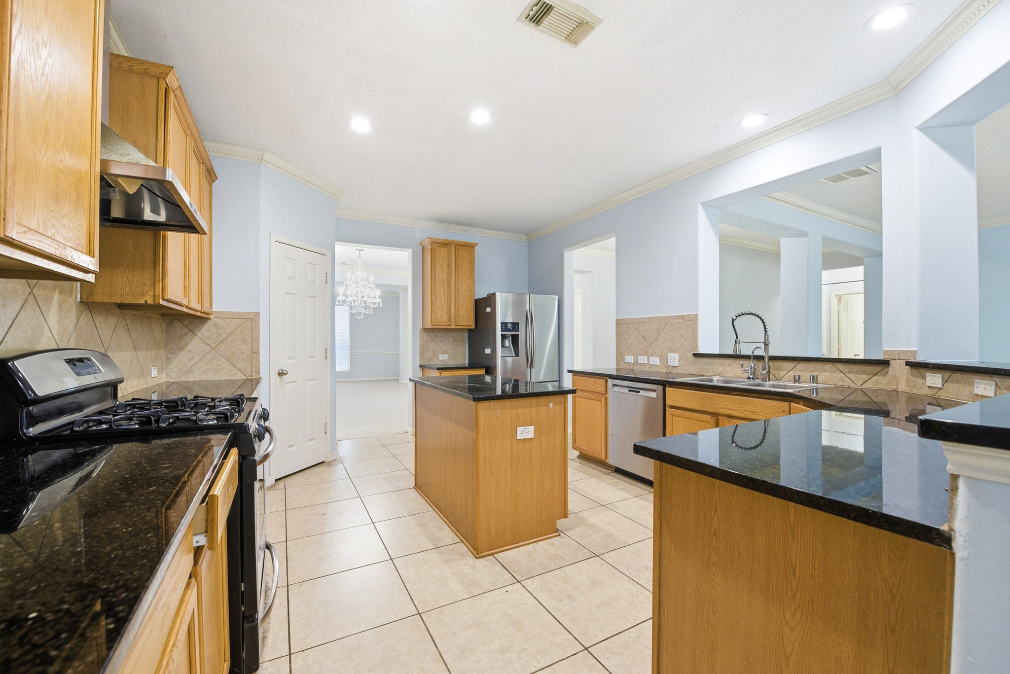 12522 East Nantucket Road Sugar Land, TX 77478 - Photo 14 of 39 a kitchen with stainless steel appliances granite countertop a sink and a stove