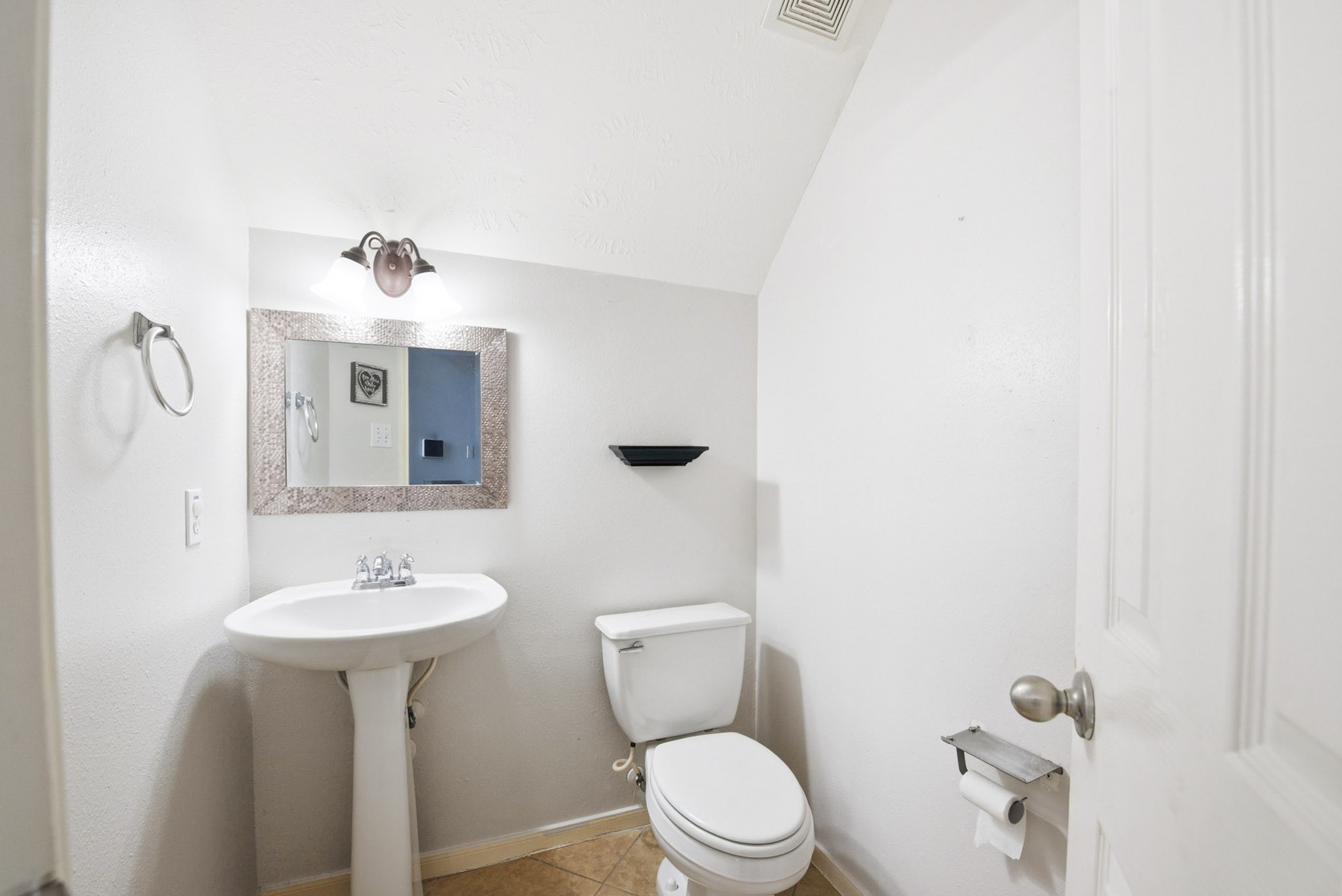 12522 East Nantucket Road Sugar Land, TX 77478 - Photo 17 of 39 a bathroom with a toilet sink and mirror