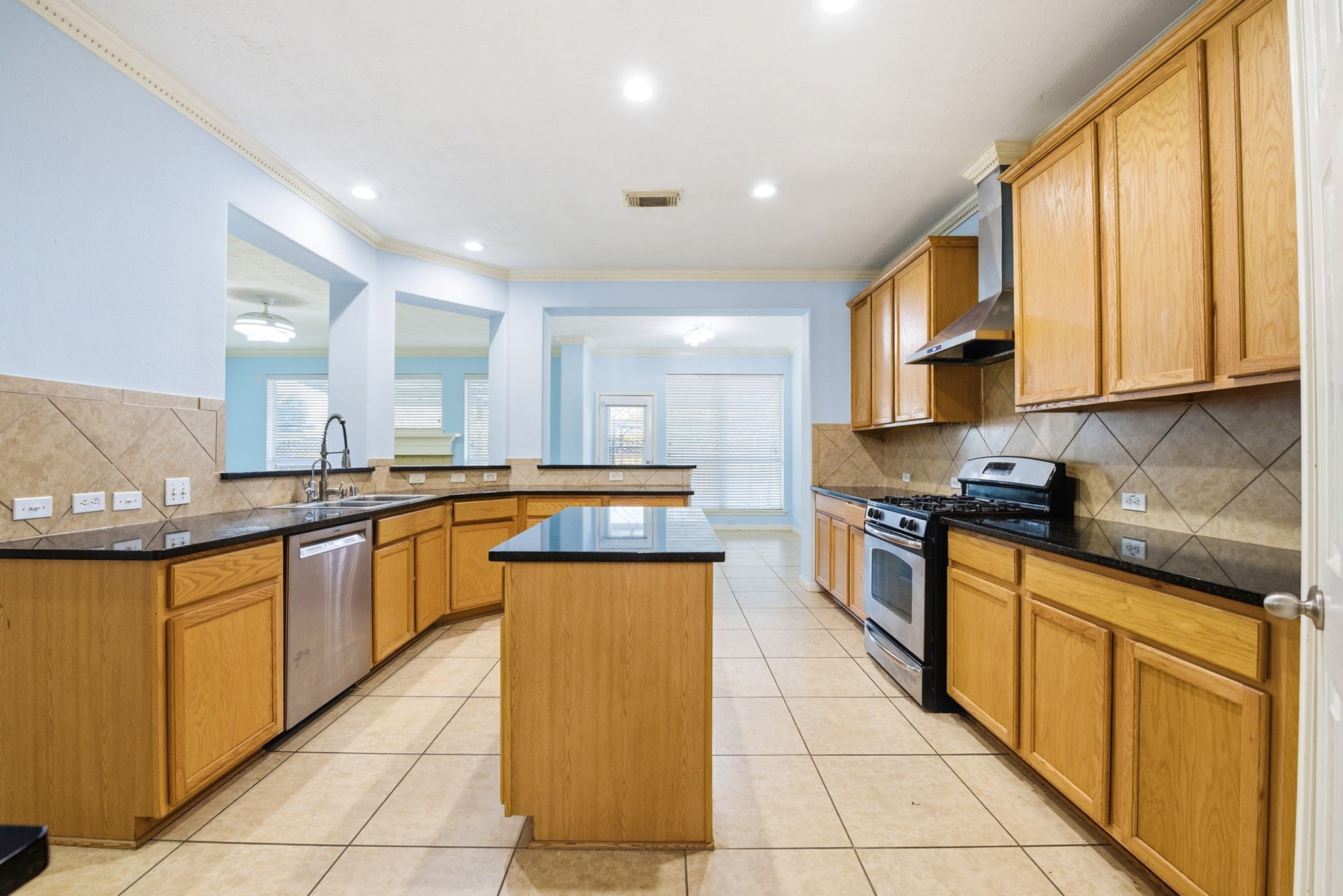 12522 East Nantucket Road Sugar Land, TX 77478 - Photo 23 of 39 a large kitchen with stainless steel appliances granite countertop a large counter top a stove top oven and cabinets