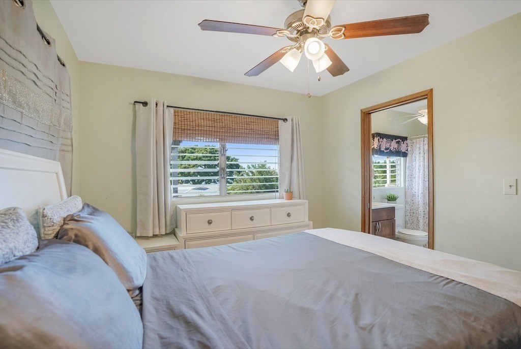 8520 Elepaio Road Kekaha, HI 96752 - Photo 15 of 30 a bedroom with a large bed and a window