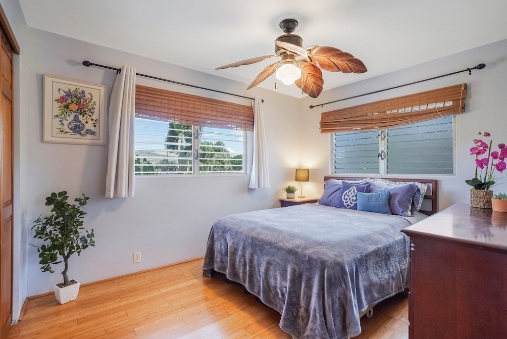 8520 Elepaio Road Kekaha, HI 96752 - Photo 18 of 30 a bedroom with a bed and a potted plant