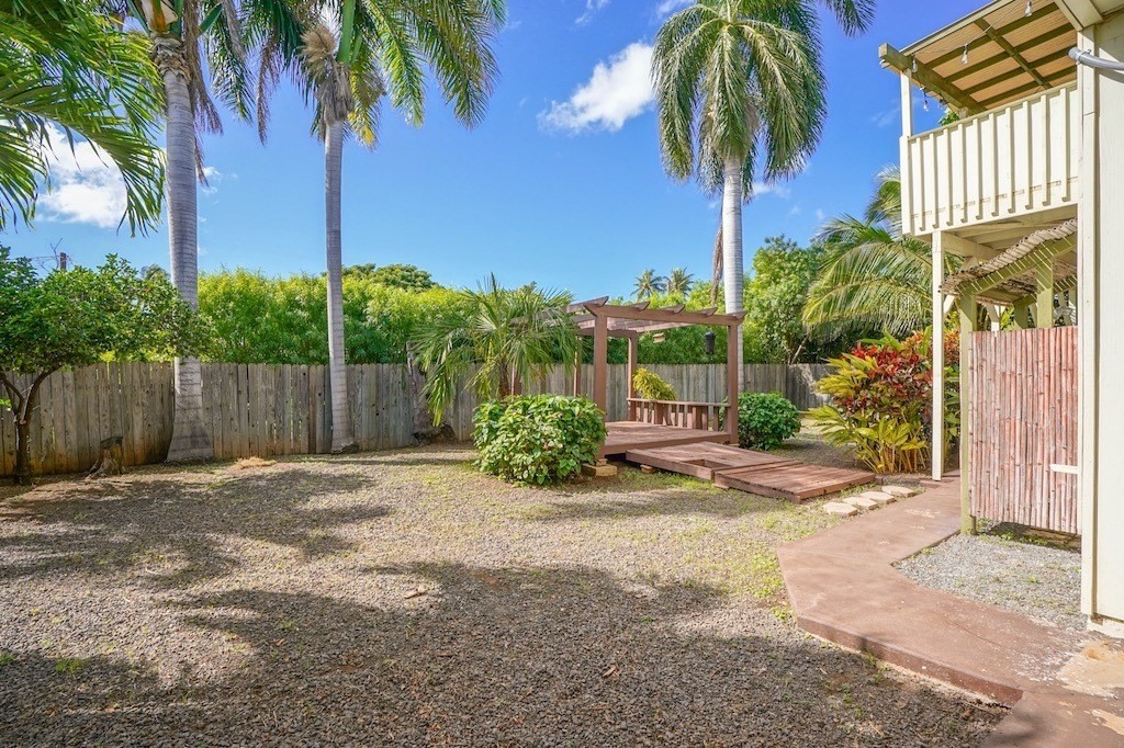 8520 Elepaio Road Kekaha, HI 96752 - Photo 27 of 30 a row of palm trees and a yard with wooden fence