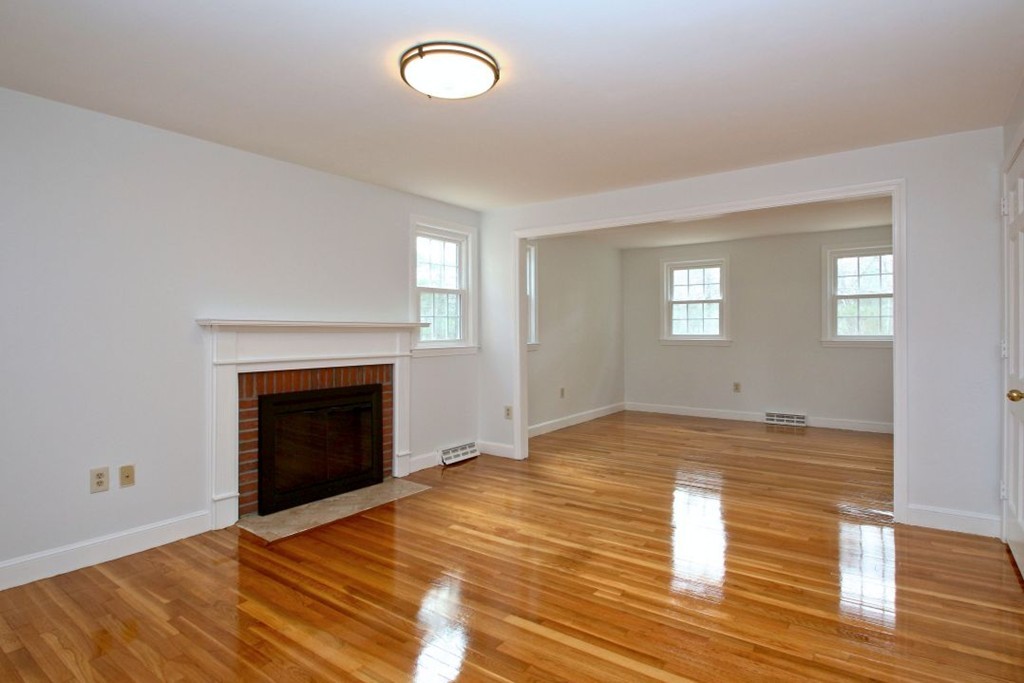 23 Campbell Road Wayland, MA 01778 - Photo 13 of 24 a view of empty room with wooden floor and fireplace