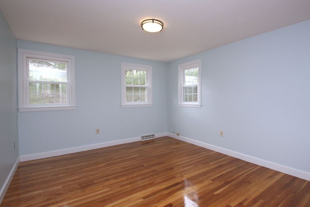 23 Campbell Road Wayland, MA 01778 - Photo 15 of 24 an empty room with wooden floor and windows
