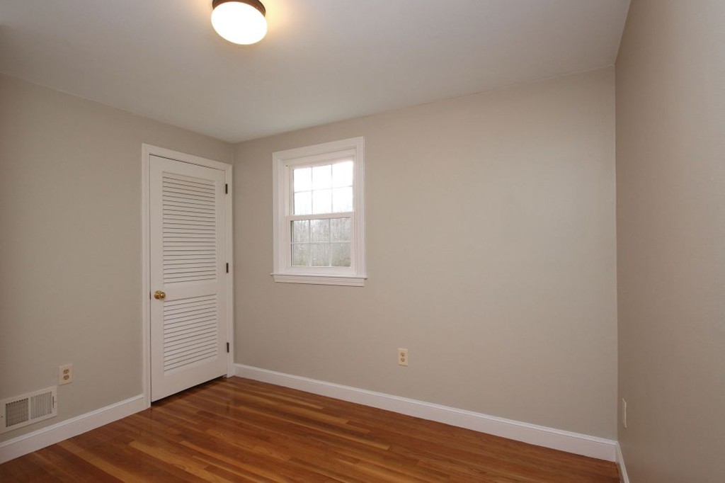 23 Campbell Road Wayland, MA 01778 - Photo 17 of 24 an empty room with wooden floor and windows