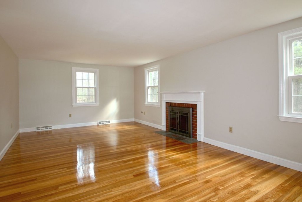 23 Campbell Road Wayland, MA 01778 - Photo 4 of 24 a view of empty room with wooden floor and fireplace