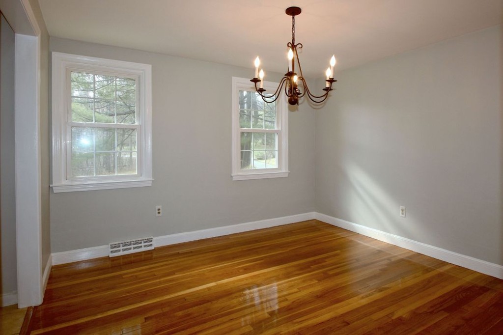23 Campbell Road Wayland, MA 01778 - Photo 5 of 24 a view of a room with wooden floor and chandelier