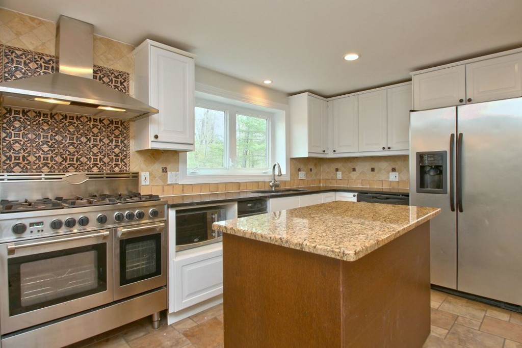 23 Campbell Road Wayland, MA 01778 - Photo 8 of 24 a kitchen with stainless steel appliances granite countertop a sink stove and refrigerator