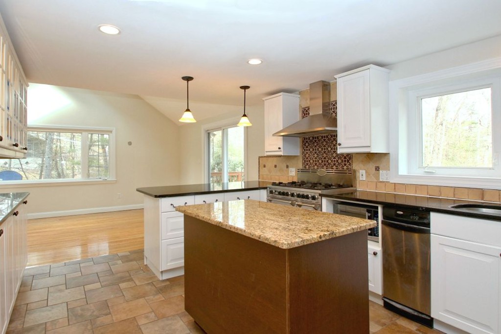 23 Campbell Road Wayland, MA 01778 - Photo 9 of 24 a kitchen with kitchen island granite countertop a sink stove and cabinets