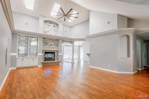a living room with a fireplace and wooden floor