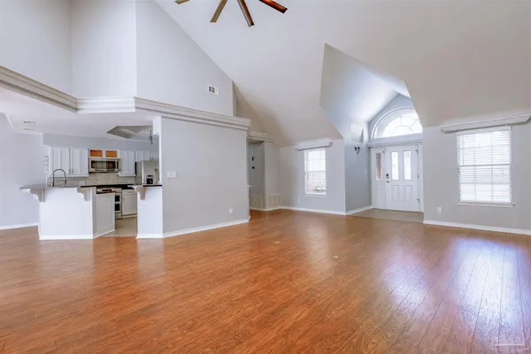 a kitchen with stainless steel appliances kitchen island granite countertop a refrigerator a stove and a sink