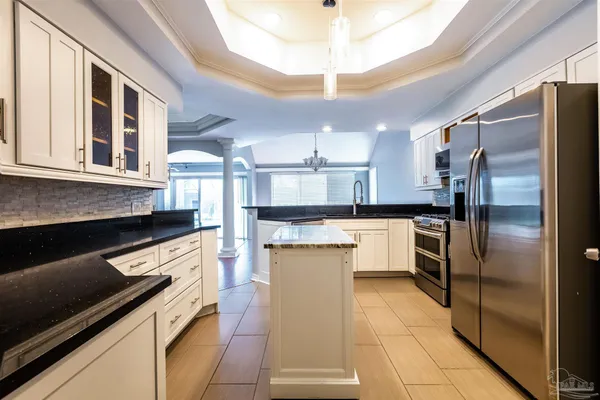 a kitchen with stainless steel appliances granite countertop a stove and a sink
