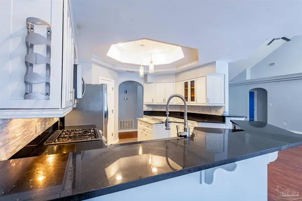 a kitchen that has a sink and a stove in it