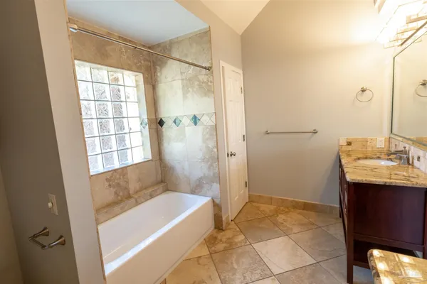 a bathroom with a double vanity sink and mirror