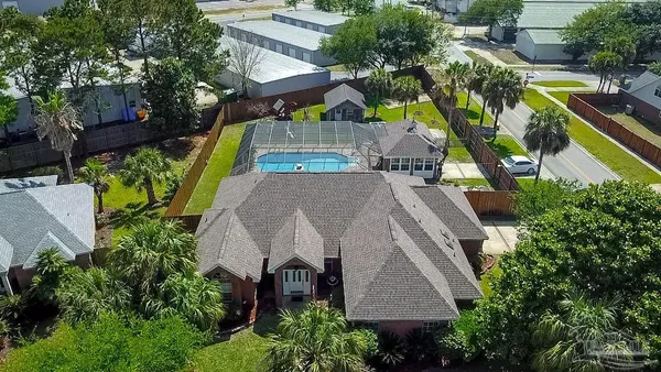 an aerial view of a house with a yard and potted plants