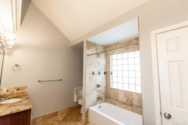 a view of empty room with window and ceiling fan