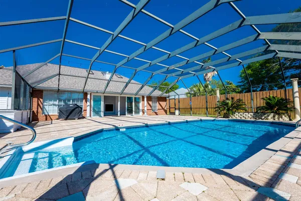 a house with swimming pool in front of it