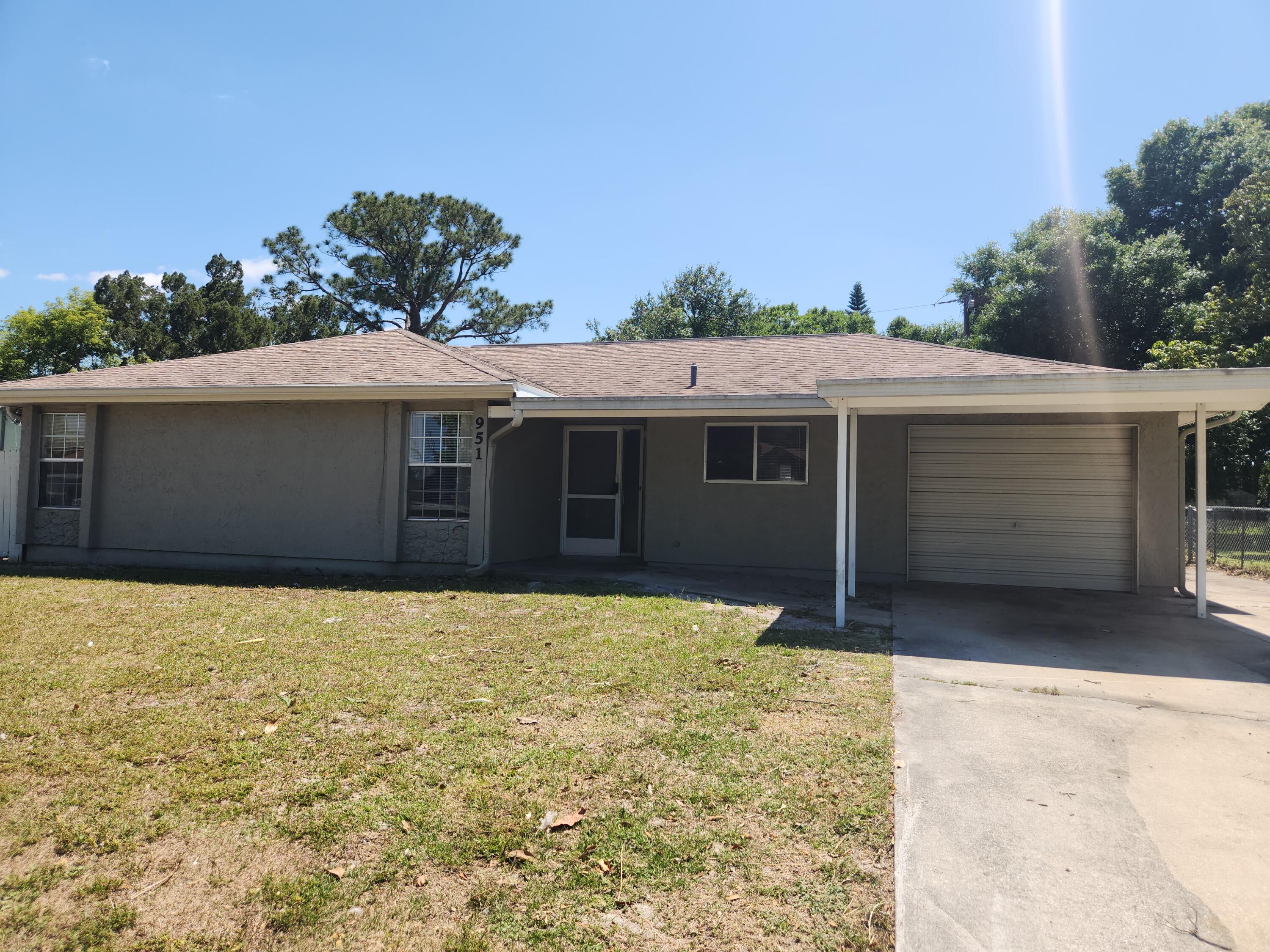 951 Palm Street Cocoa, FL 32927 - Photo 1 of 34 a house with trees in the background