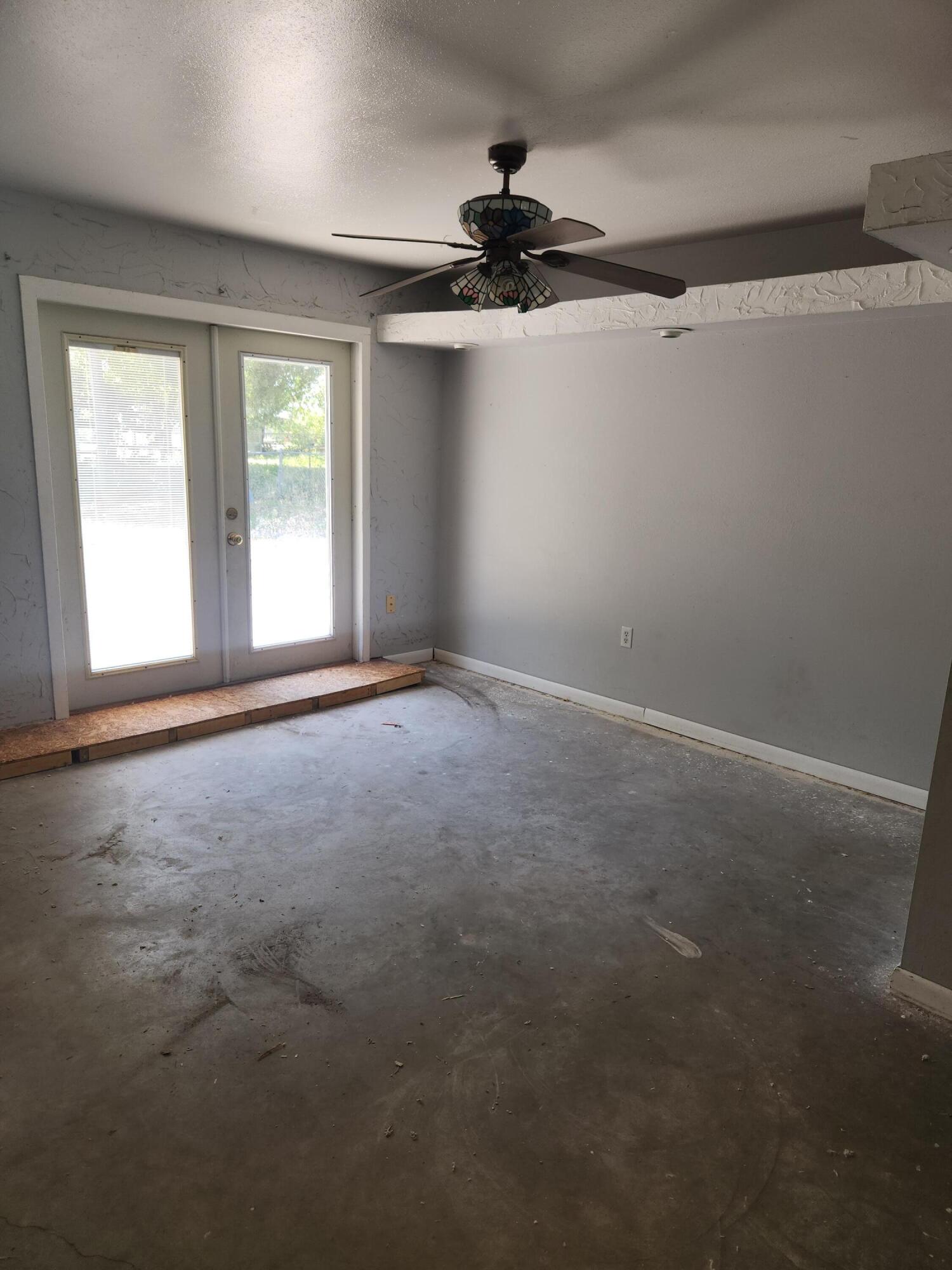 951 Palm Street Cocoa, FL 32927 - Photo 9 of 34 a view of a big room with windows and chandelier fan
