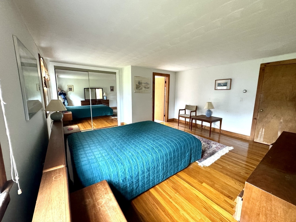 24 Shore Road West Dennis, MA 02670 - Photo 12 of 28 a living room with blue walls with furniture and a table