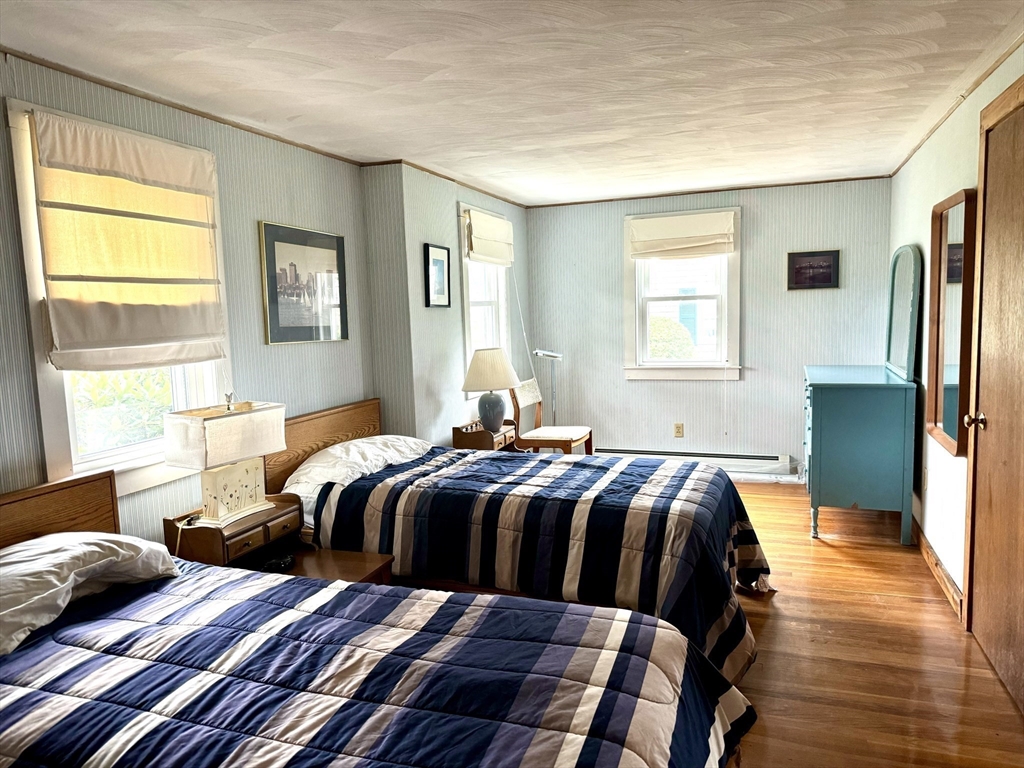 24 Shore Road West Dennis, MA 02670 - Photo 13 of 28 a bedroom with a bed and wooden floor