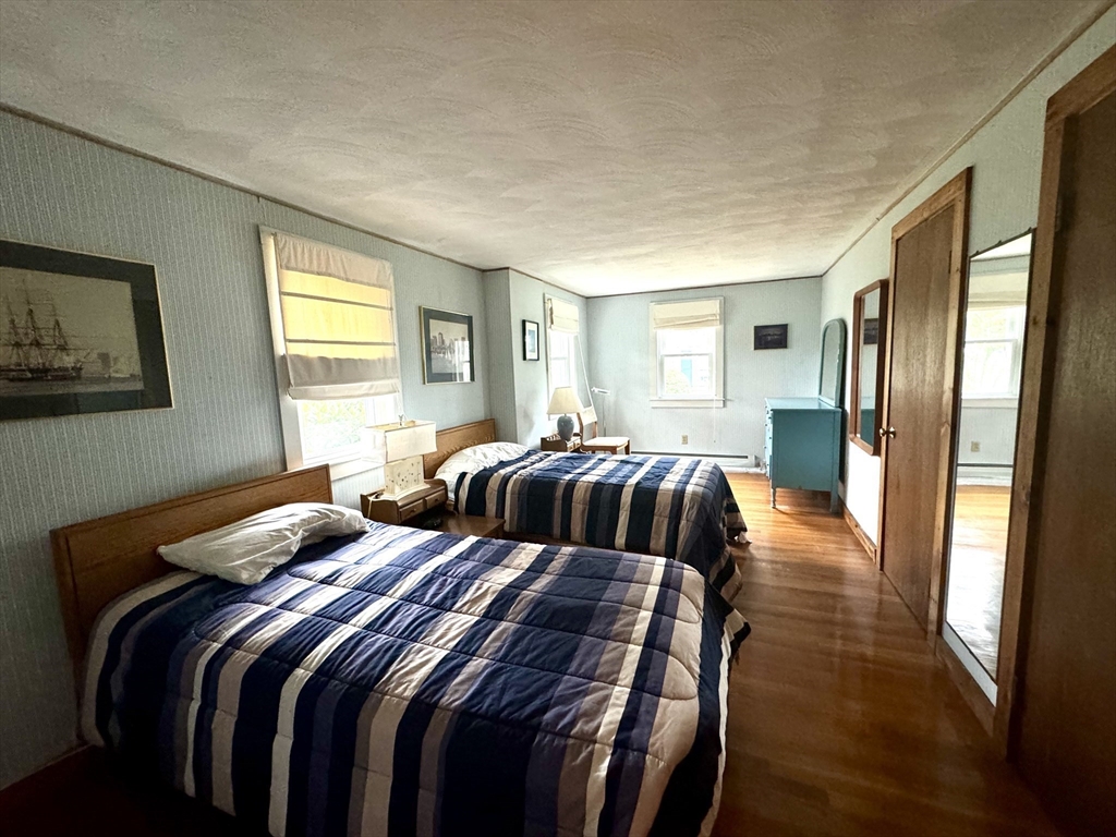24 Shore Road West Dennis, MA 02670 - Photo 14 of 28 a bedroom with double bed and a window