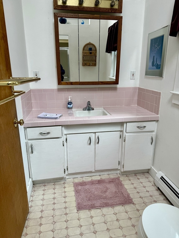 24 Shore Road West Dennis, MA 02670 - Photo 18 of 28 a bathroom with a sink a toilet and mirror