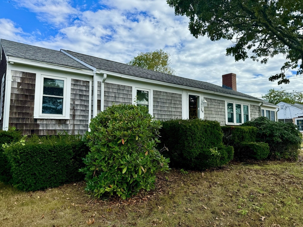 24 Shore Road West Dennis, MA 02670 - Photo 22 of 28 a front view of a house with a garden