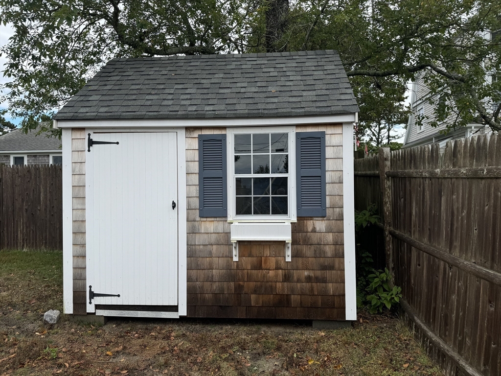 24 Shore Road West Dennis, MA 02670 - Photo 23 of 28 a front view of a house with a porch