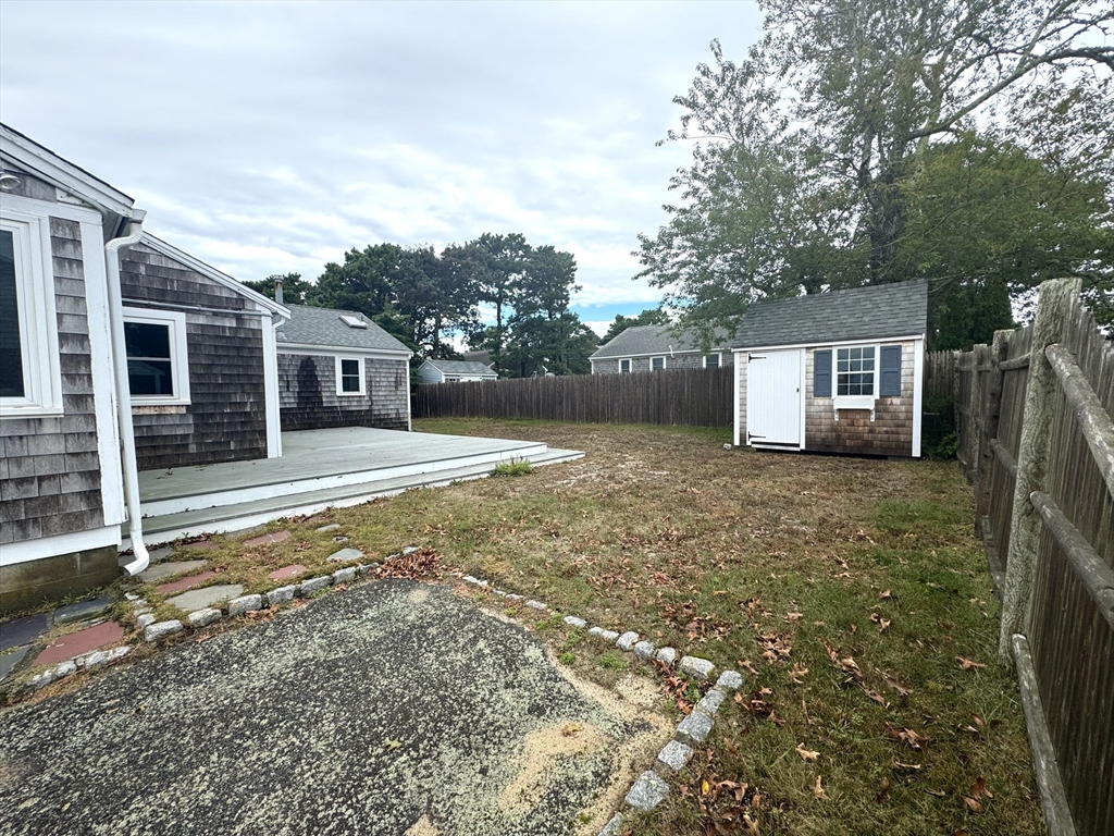24 Shore Road West Dennis, MA 02670 - Photo 4 of 28 front view of a house with a yard