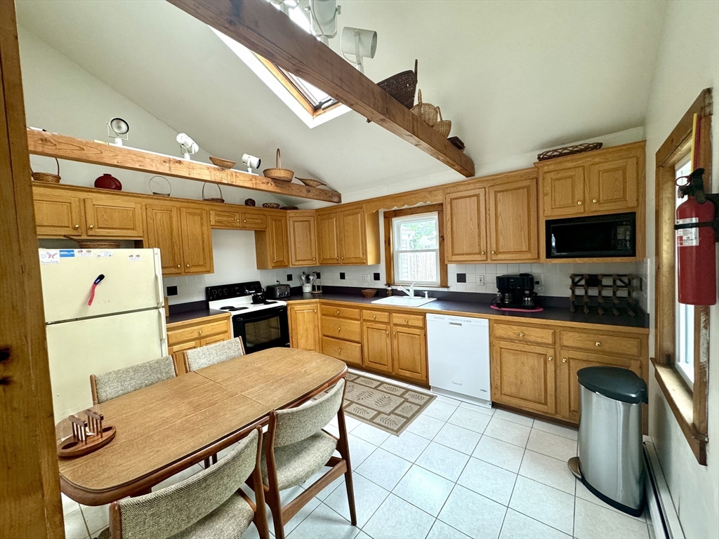 24 Shore Road West Dennis, MA 02670 - Photo 7 of 28 a kitchen with stainless steel appliances kitchen island granite countertop a sink and cabinets