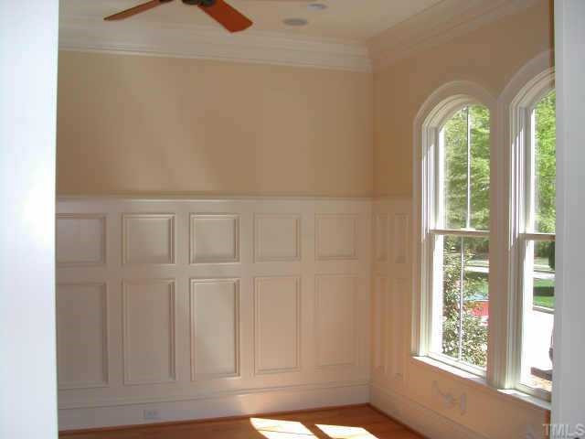 7830 Monument Lane Raleigh, NC 27615 - Photo 9 of 10 Library features Wainscoting, Ceiling Fan and Eight Foot Pocket Doors Other