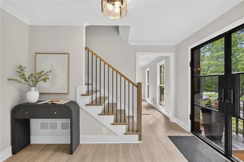 a view of entryway and hall with wooden floor