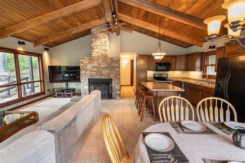 2226 County Line Road Champion, PA 15622 - Photo 8 of 33 a dining room with furniture a fireplace and wooden floor