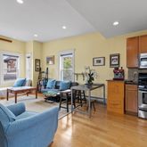 a living room with furniture wooden floor and a window