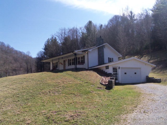 727 Teaberry Road Warrensville, NC 28693 - Photo 1 of 15 a front view of a house with a yard