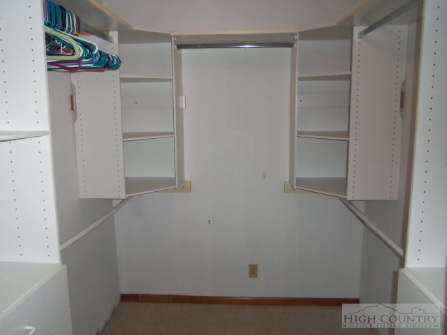 727 Teaberry Road Warrensville, NC 28693 - Photo 11 of 15 a view of walk in closet with empty racks