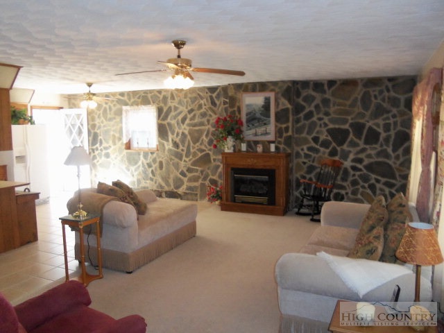 727 Teaberry Road Warrensville, NC 28693 - Photo 13 of 15 a living room with furniture and a fireplace