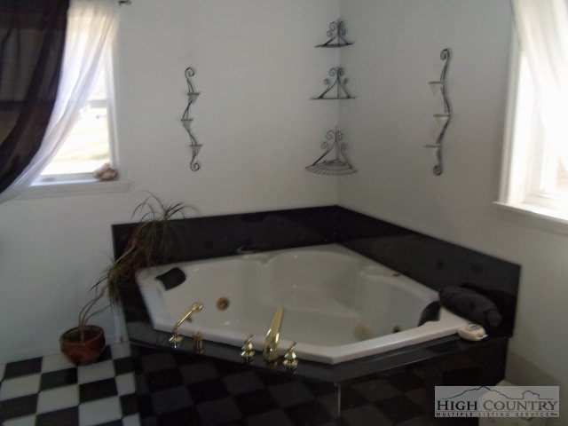 727 Teaberry Road Warrensville, NC 28693 - Photo 10 of 15 a bath tub sitting in a bathroom next to a window