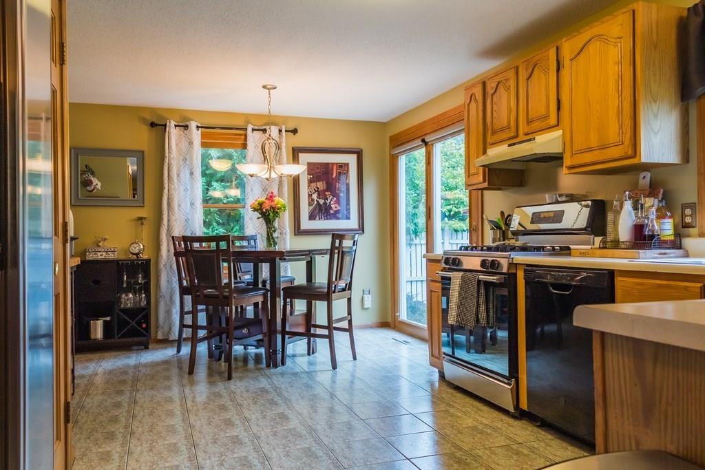 45 Winterset Drive Springfield, MA 01129 - Photo 7 of 21 a kitchen with stainless steel appliances granite countertop a stove top oven a dining table and chairs with wooden floor