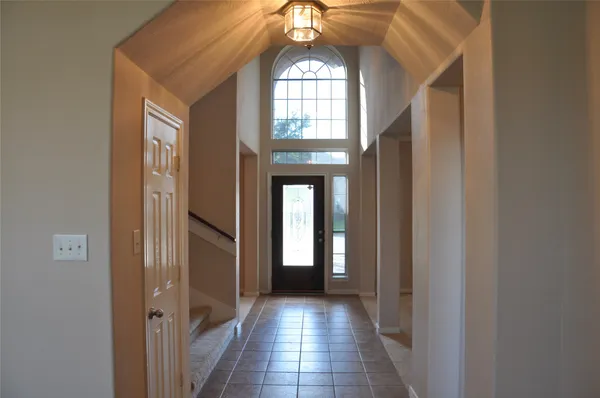 a view of entryway with a grandfather clock and a large mirror