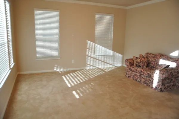 a view of an empty room and a window