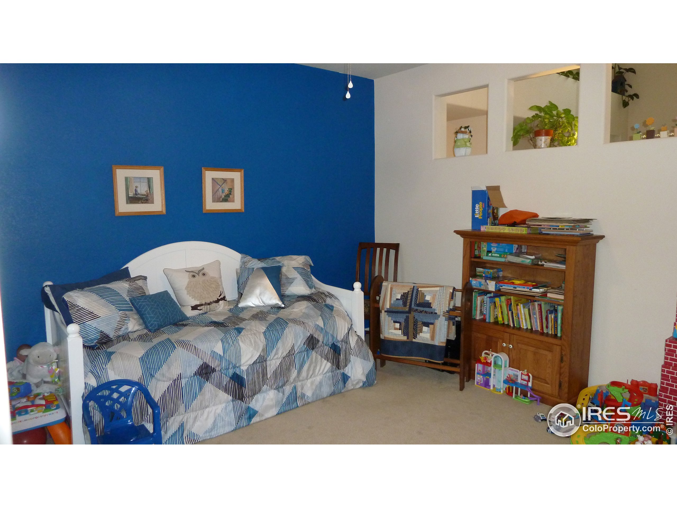8121 Raspberry Drive Frederick, CO 80504 - Photo 12 of 38 a living room with furniture and a shelf